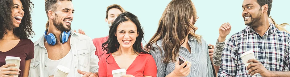 Group of smiling college students walking with coffee